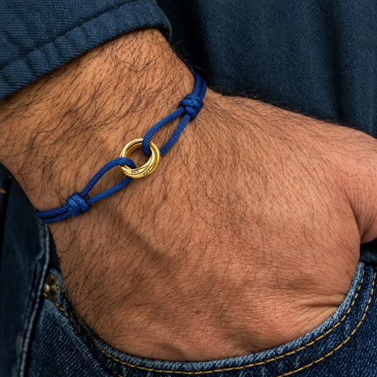 Black cord bracelet with 18K gold twisted knot/ring charm, adjustable sliding knot closure
